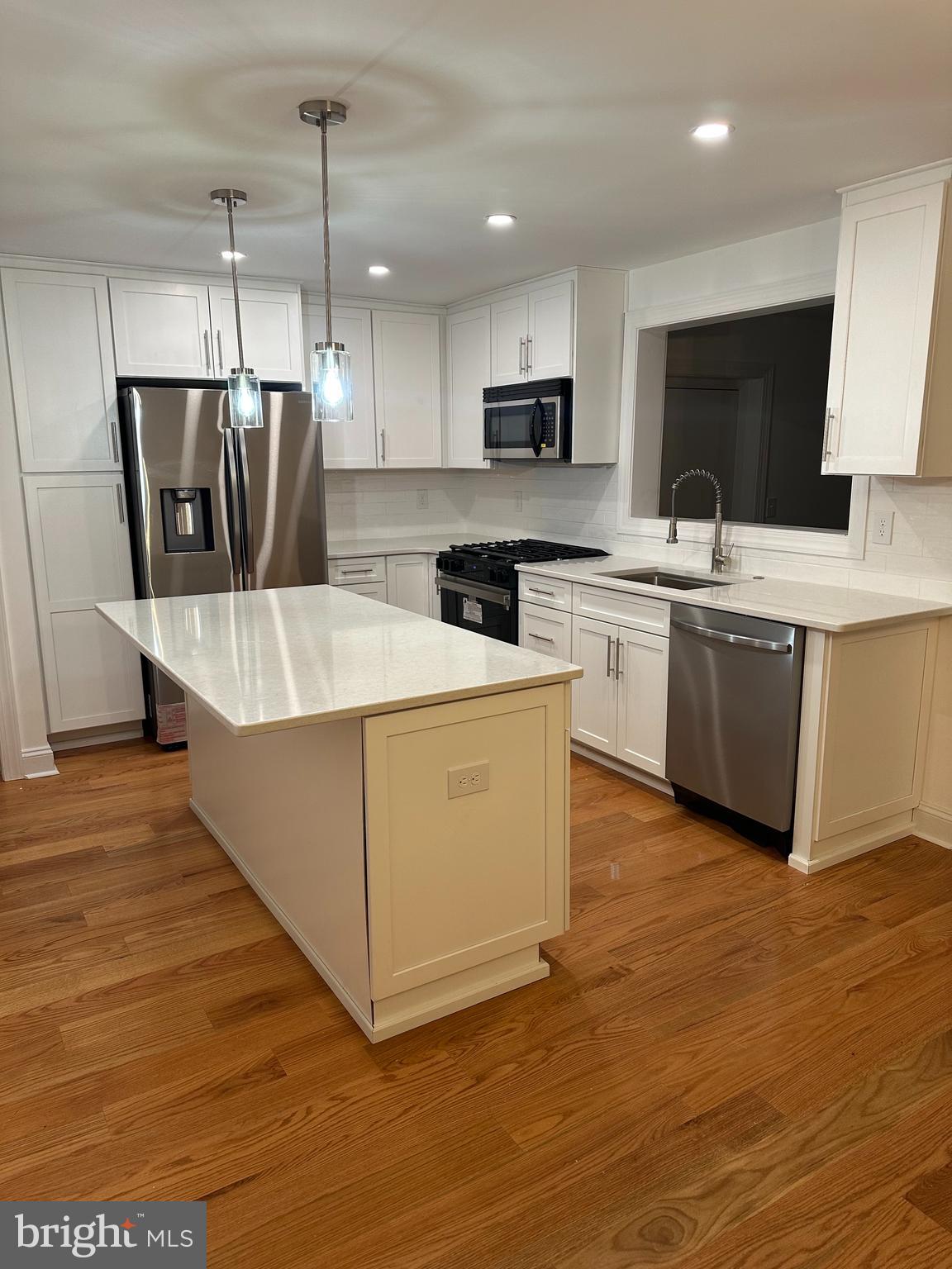 212 Grandview Road Media, PA 19063 - Photo 48 of 49 a living room with stainless steel appliances kitchen island granite countertop a stove top oven a sink dishwasher and a refrigerator with wooden floor