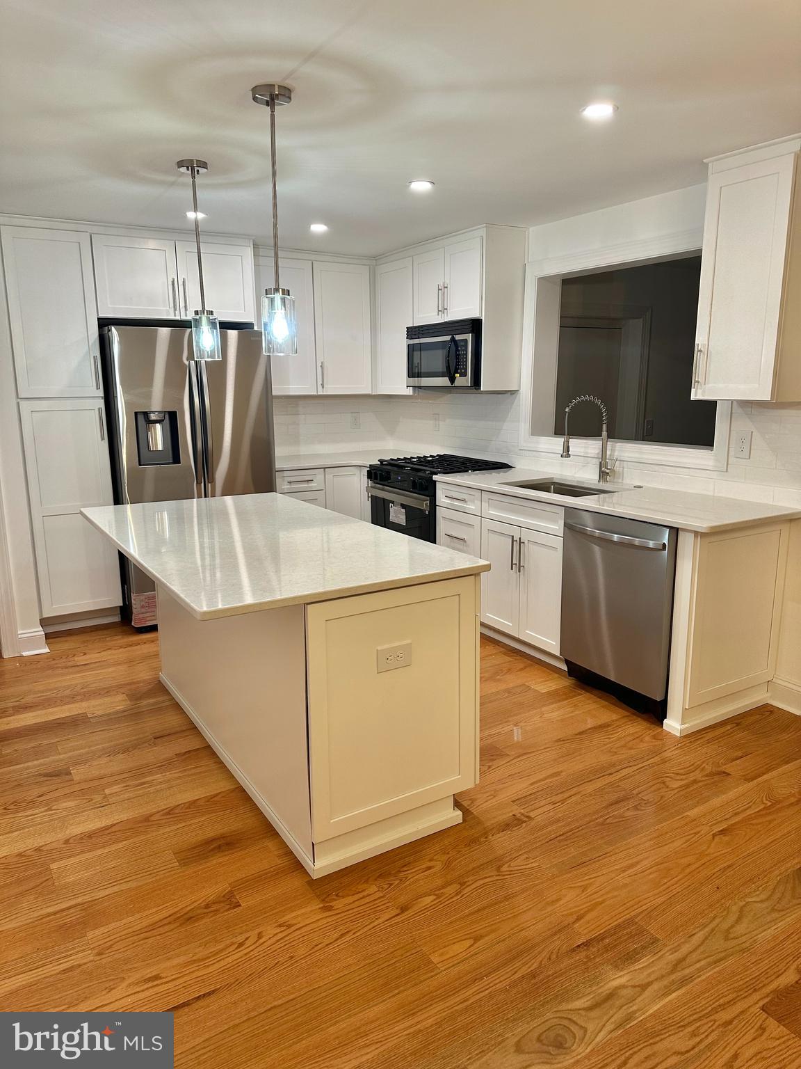 212 Grandview Road Media, PA 19063 - Photo 8 of 49 a large kitchen with stainless steel appliances granite countertop a stove a sink dishwasher and a refrigerator with wooden floor