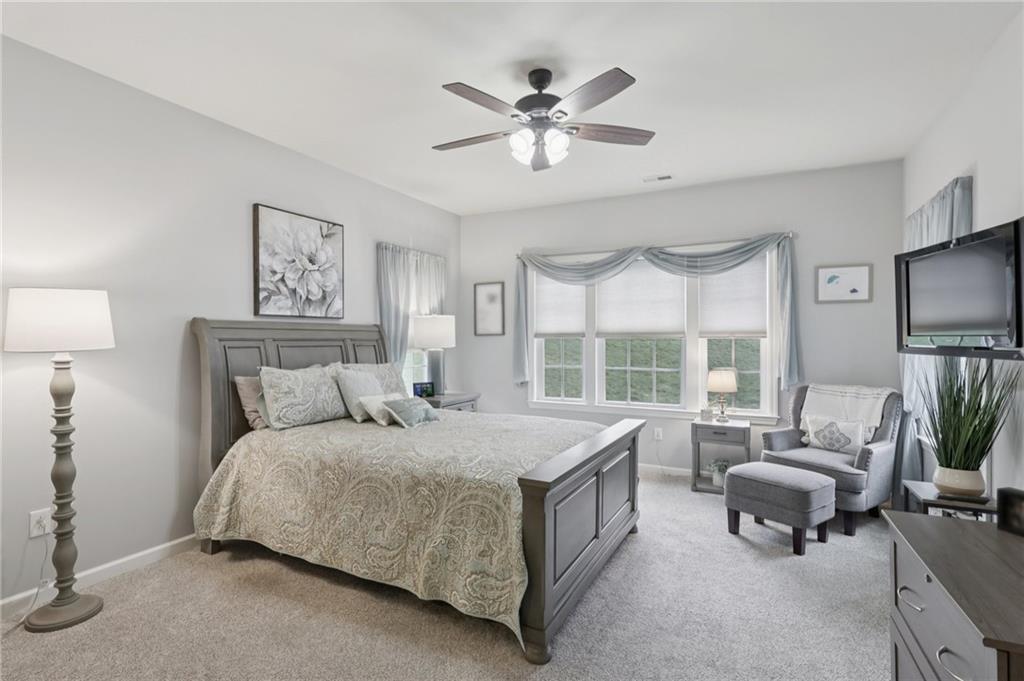 122 Liberty Lane Freedom, PA 15042 - Photo 17 of 50 a spacious bedroom with a bed a couch and a chandelier