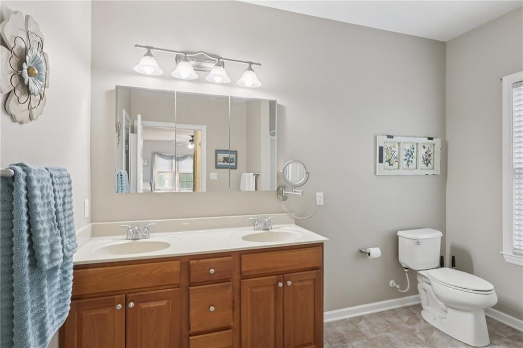 122 Liberty Lane Freedom, PA 15042 - Photo 19 of 50 a bathroom with a toilet a sink and mirror