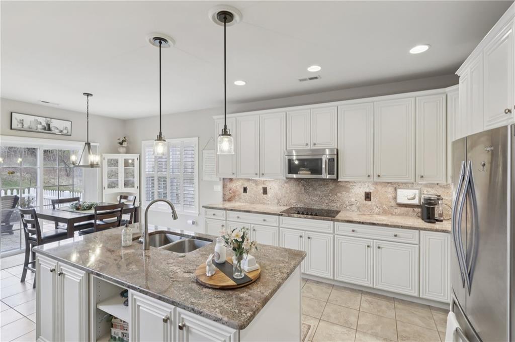 122 Liberty Lane Freedom, PA 15042 - Photo 9 of 50 a kitchen with stainless steel appliances granite countertop a sink a stove and a wooden floors