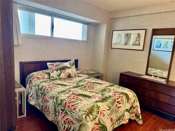 a bed sitting in a bedroom next to a window