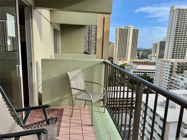 a view of a balcony with wooden floor and fence