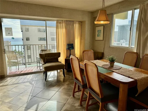 a view of a dining room with furniture and a window