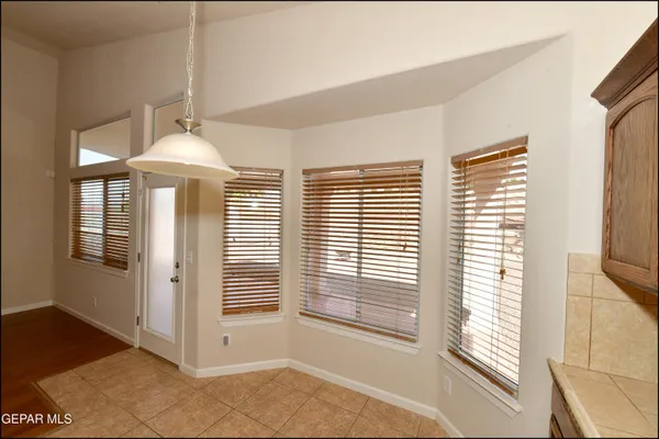 a large kitchen with stainless steel appliances granite countertop a sink stove and refrigerator