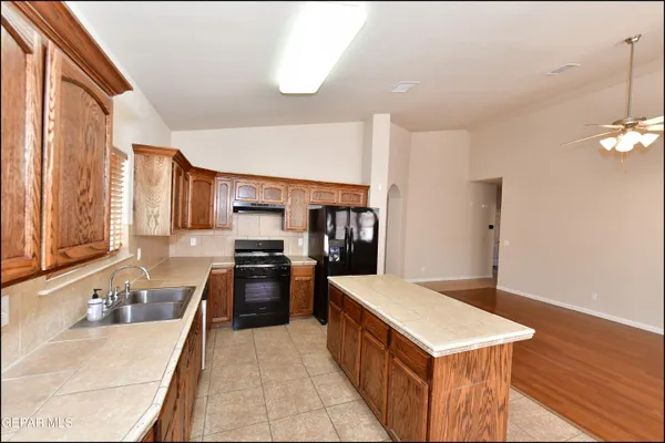 a large kitchen with a sink and cabinets