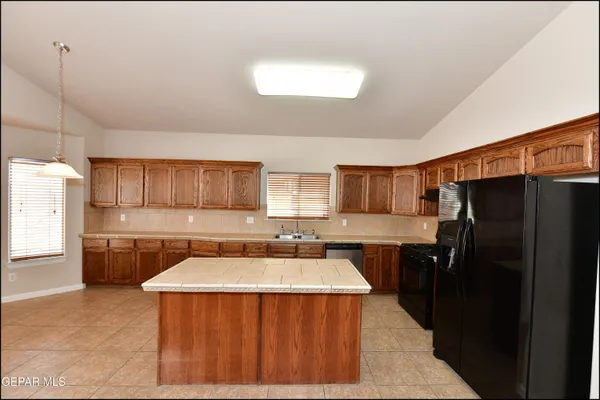 a kitchen with a refrigerator and a sink