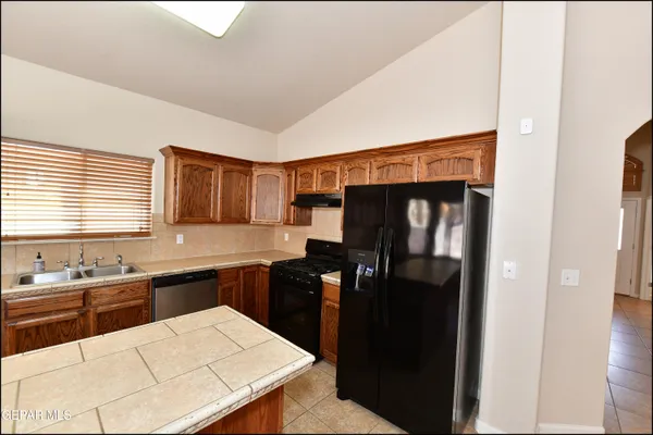 a kitchen with stainless steel appliances granite countertop a stove and a sink