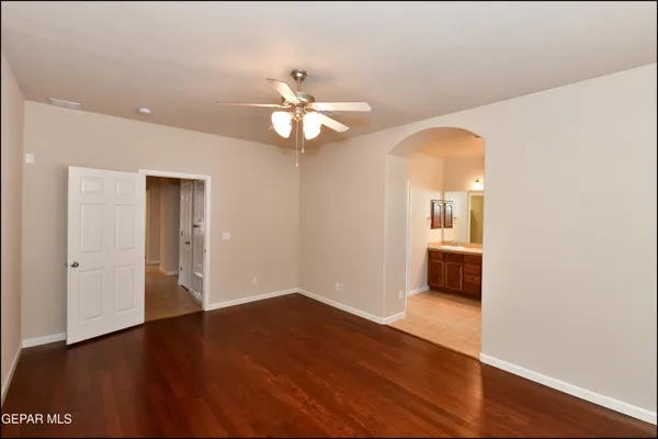 a spacious bathroom with a granite countertop sink a toilet mirror and a bathtub