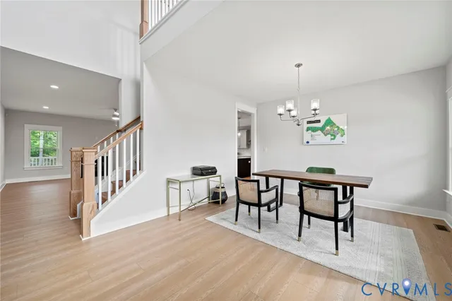 a view of a dining room with furniture wooden floor and chandelier
