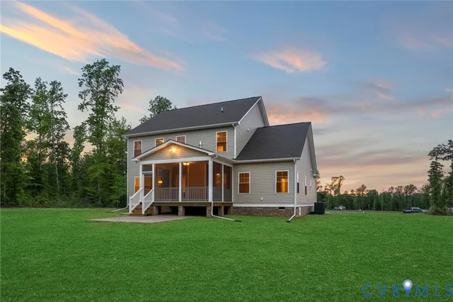 a front view of a house with a yard and trees
