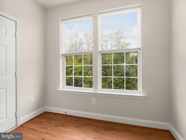 an empty room with windows and painted walls
