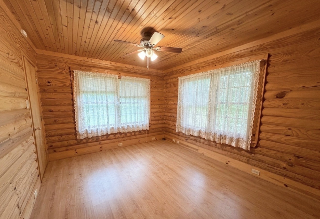 33315 Fulshear Farms Road Fulshear, TX 77441 - Photo 7 of 19 a view of an empty room with wooden floor and a window