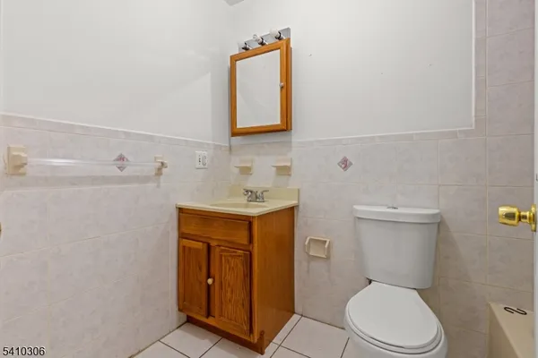 a white toilet sitting next to a bathroom sink