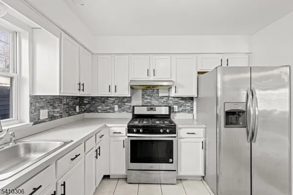 a kitchen with cabinets a sink and stainless steel appliances