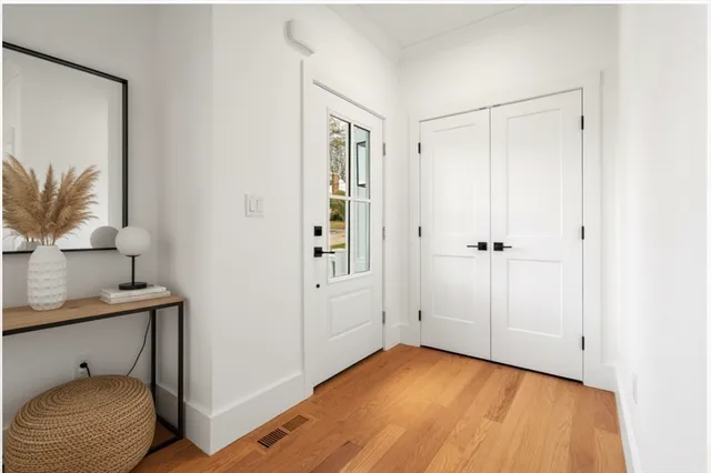 a view of entryway and hall with wooden floor