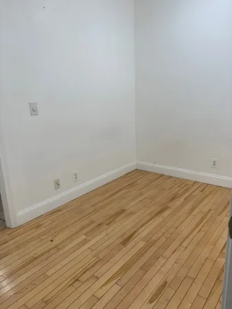 a view of a room with wooden floor