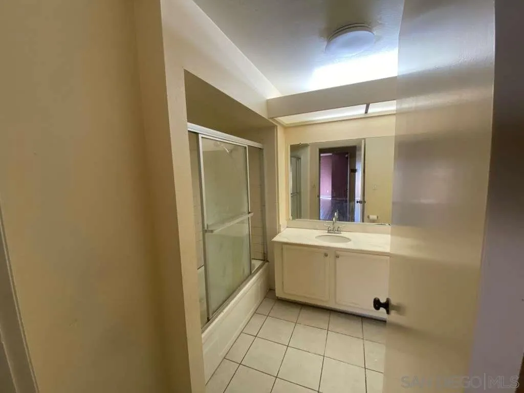 11174 Kelowna Road San Diego, CA 92126 - Photo 14 of 16 a bathroom with a mirror sink and vanity