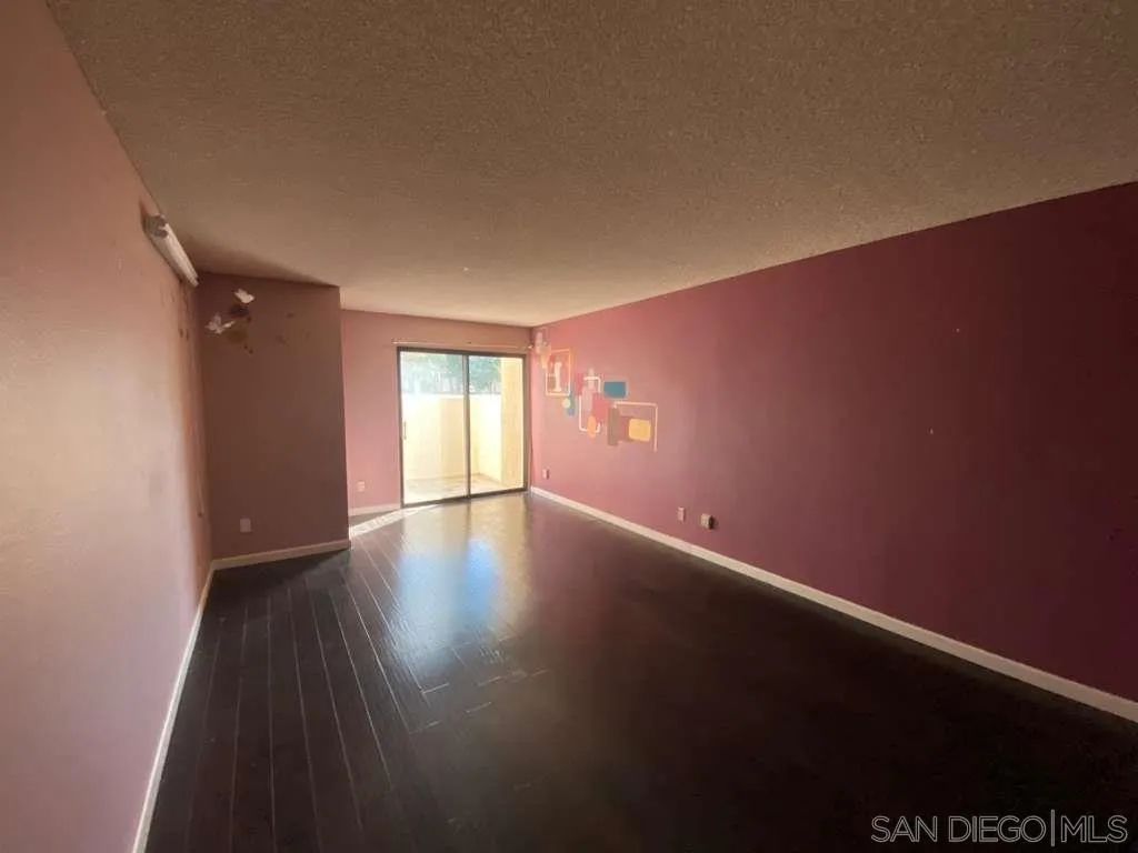 11174 Kelowna Road San Diego, CA 92126 - Photo 15 of 16 a view of an empty room with wooden floor and a window