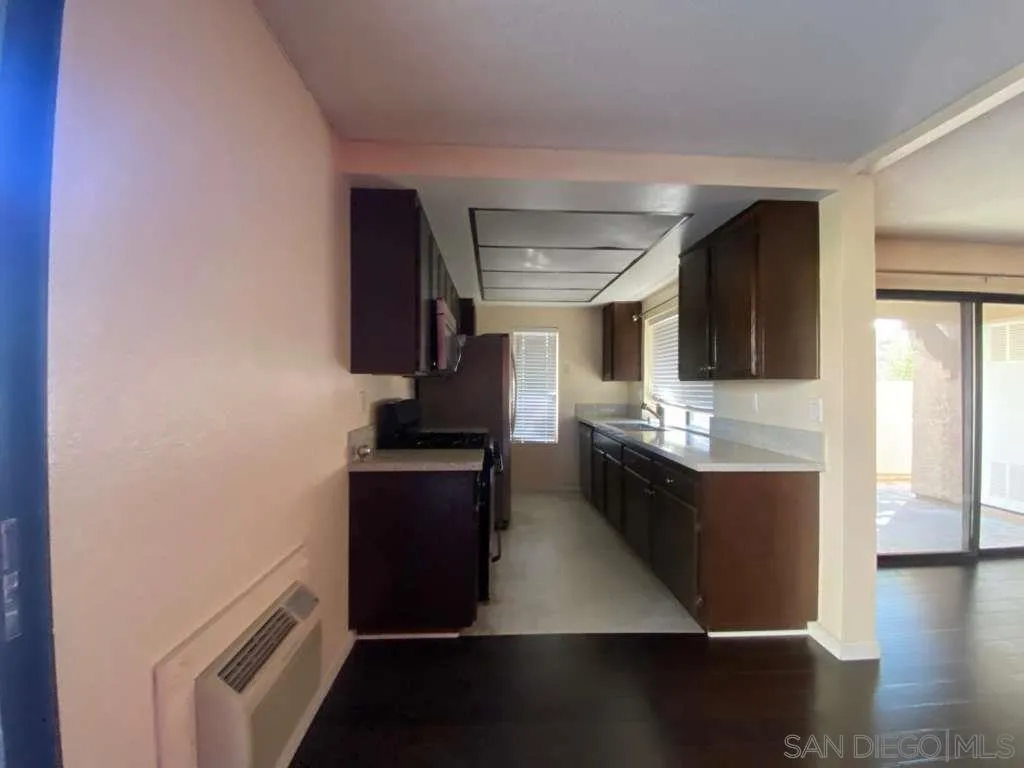 11174 Kelowna Road San Diego, CA 92126 - Photo 9 of 16 a kitchen with stainless steel appliances granite countertop a stove and a refrigerator