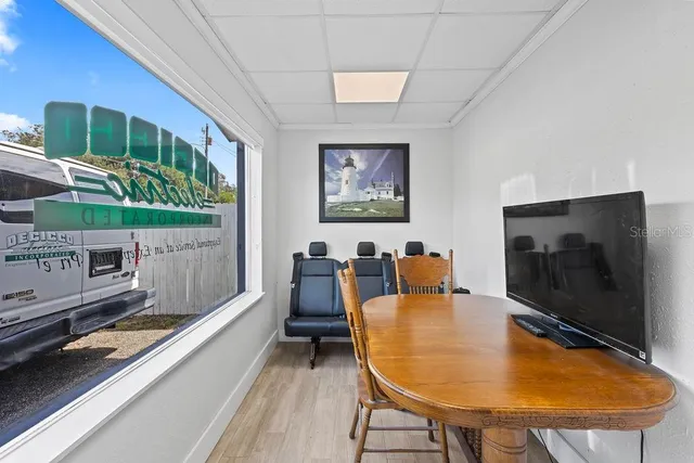 a living room with furniture pool table and a flat screen tv