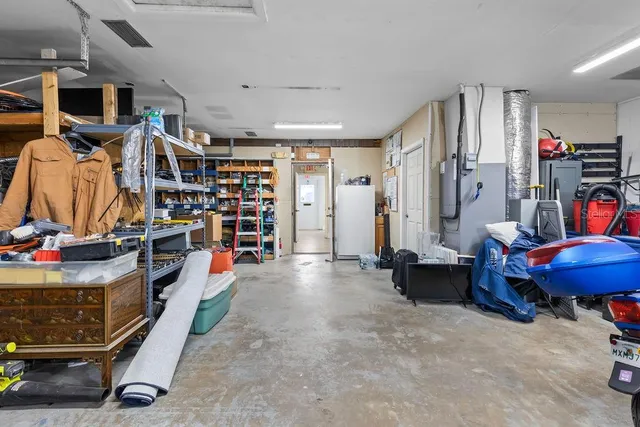 a view of a room with racks air conditioner duct and materials on floor
