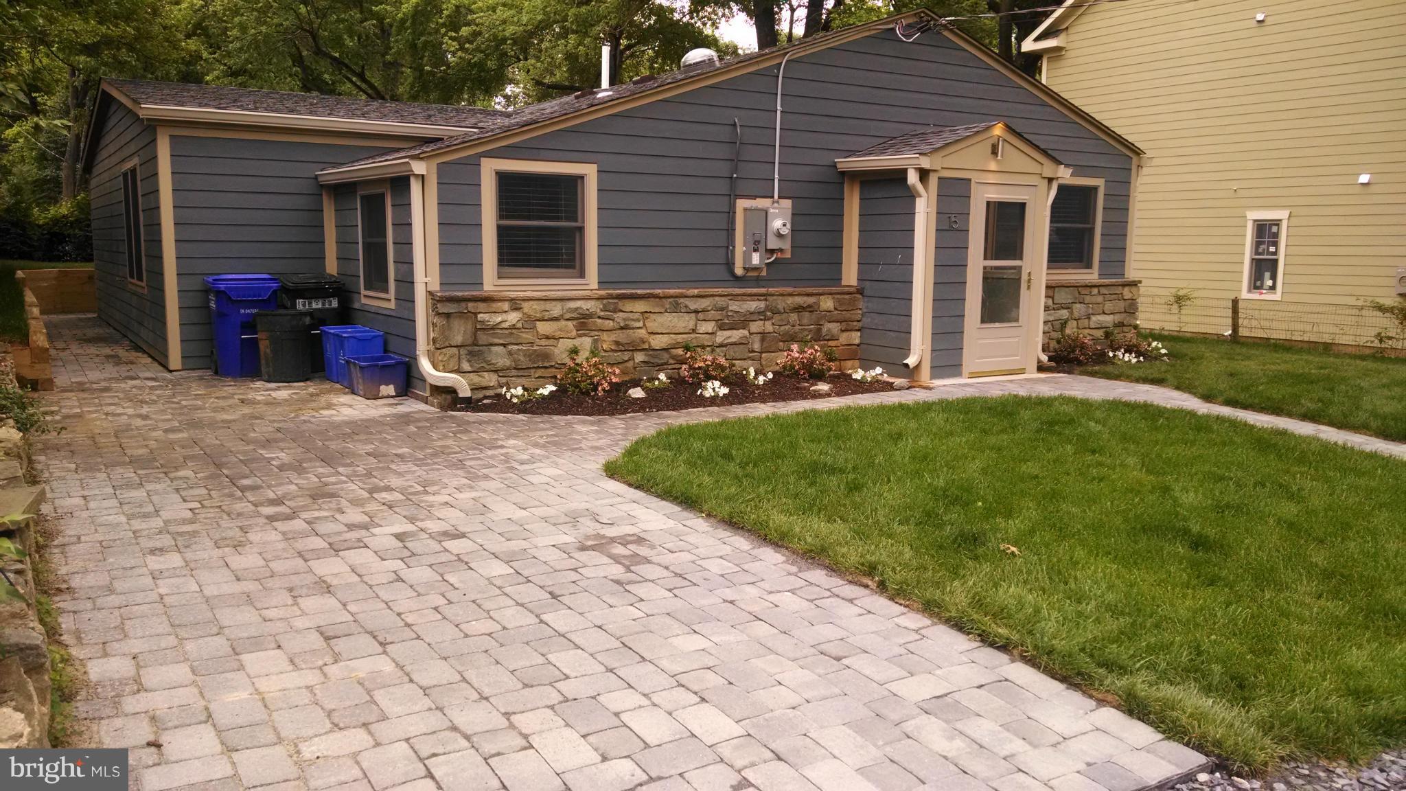 15 McKay Circle Cabin John, MD 20818 - Photo 2 of 20 a front view of a house with a yard and garage