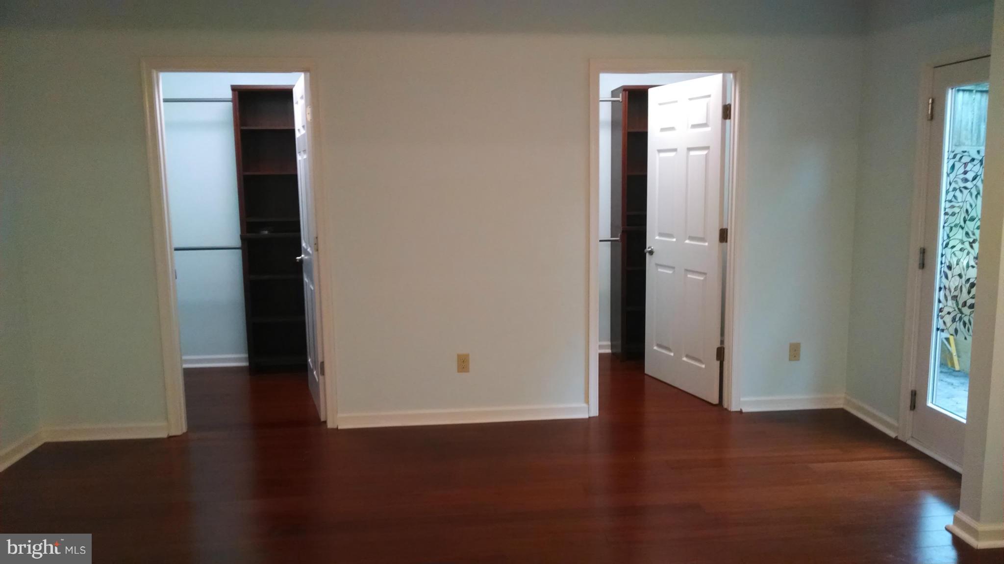 15 McKay Circle Cabin John, MD 20818 - Photo 12 of 20 an empty room with wooden floor and windows