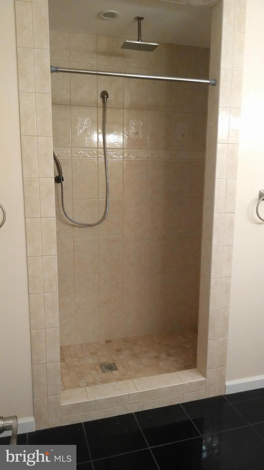 15 McKay Circle Cabin John, MD 20818 - Photo 14 of 20 a bathroom with a glass shower door