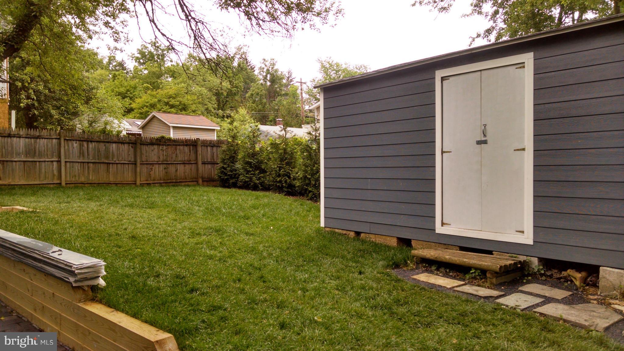 15 McKay Circle Cabin John, MD 20818 - Photo 18 of 20 a view of a backyard with plants and a bench