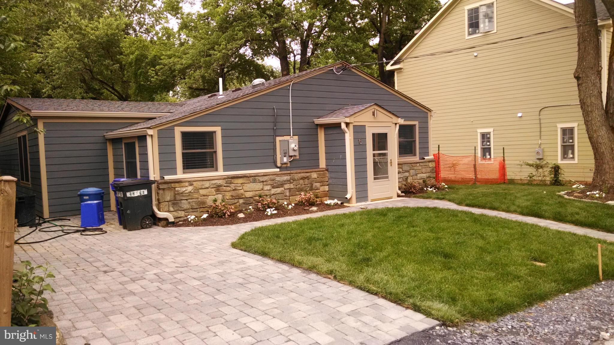 15 McKay Circle Cabin John, MD 20818 - Photo 3 of 20 a view of a house with a yard and potted plants
