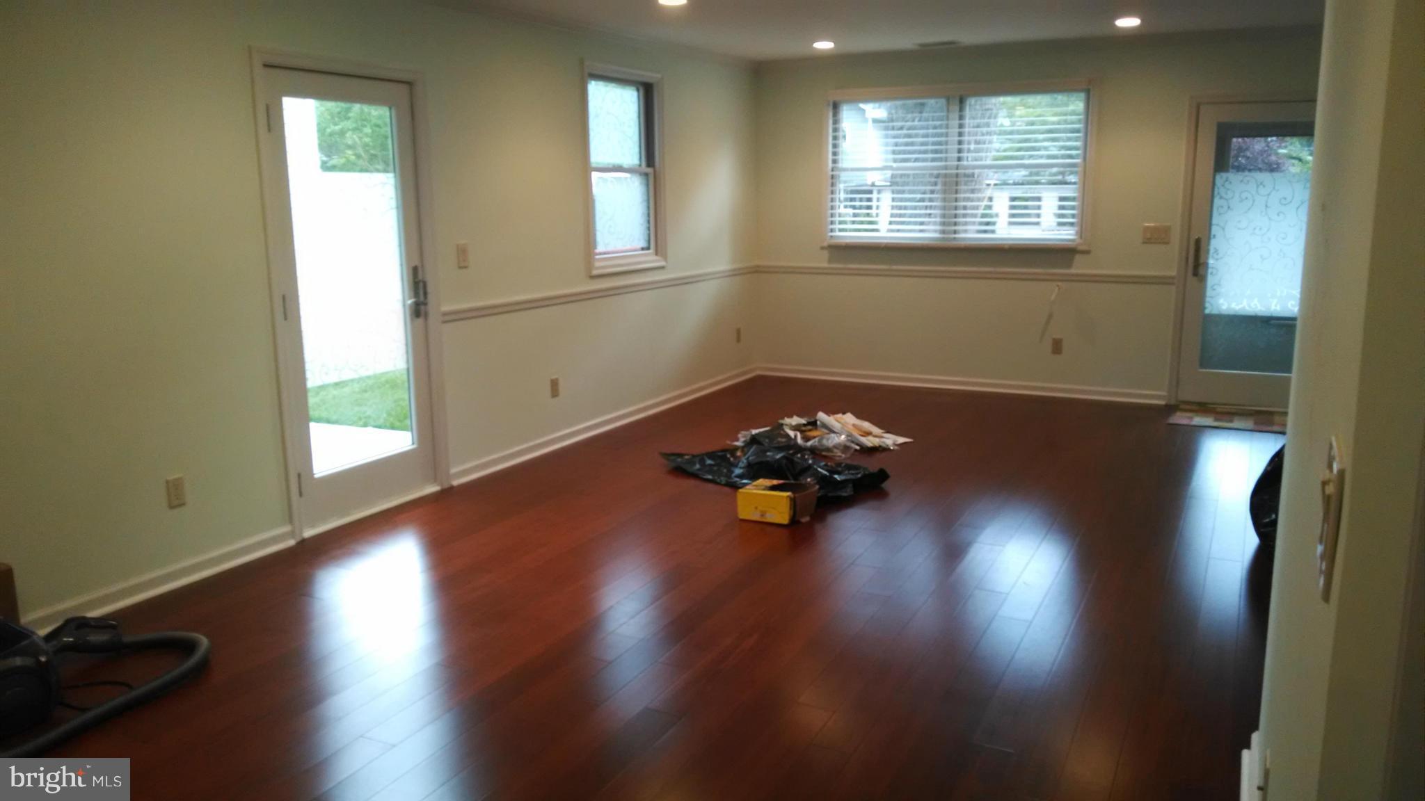 15 McKay Circle Cabin John, MD 20818 - Photo 4 of 20 an empty room with wooden floor and windows