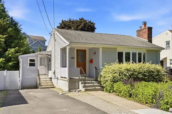 front view of a house with a bench