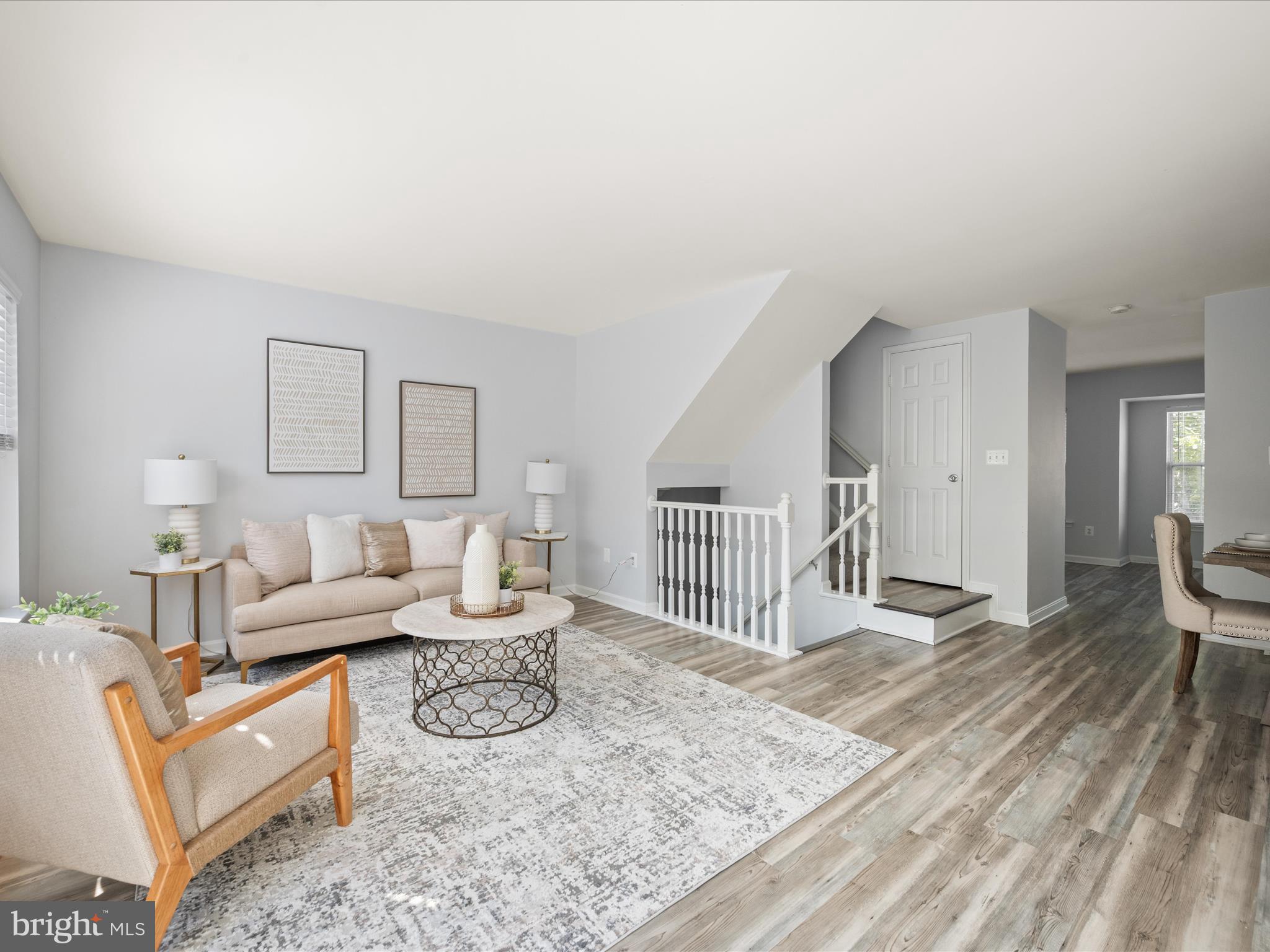20198 Brookview Square Ashburn, VA 20147 - Photo 13 of 61 a living room with furniture a flat screen tv and a table