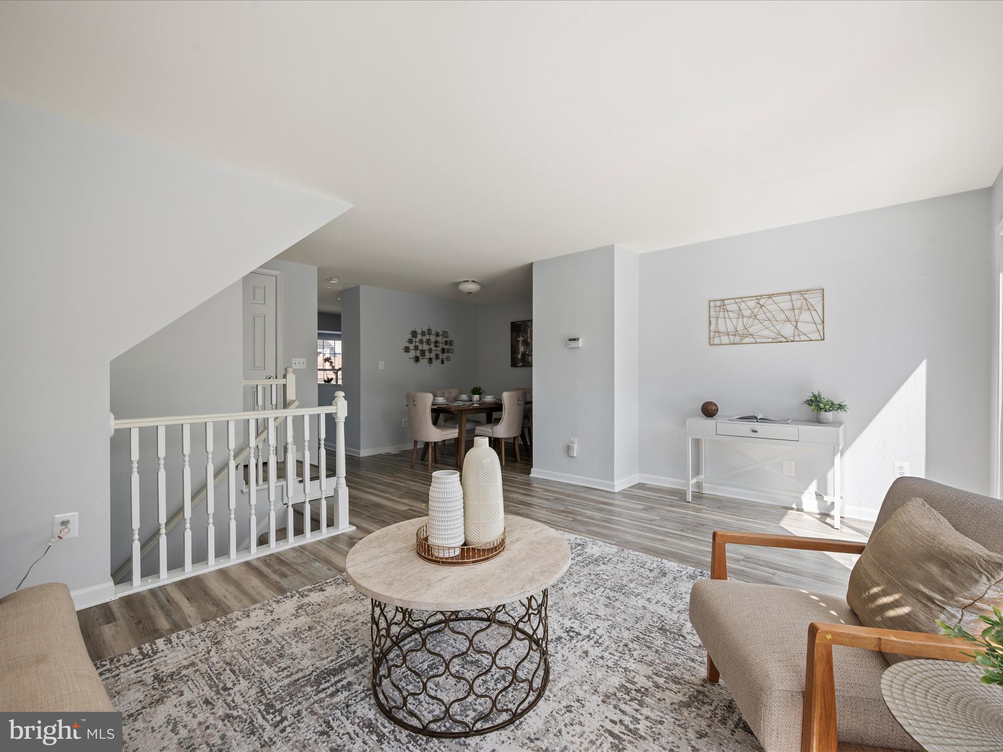 20198 Brookview Square Ashburn, VA 20147 - Photo 14 of 61 a living room with furniture a table and a chair with potted plants
