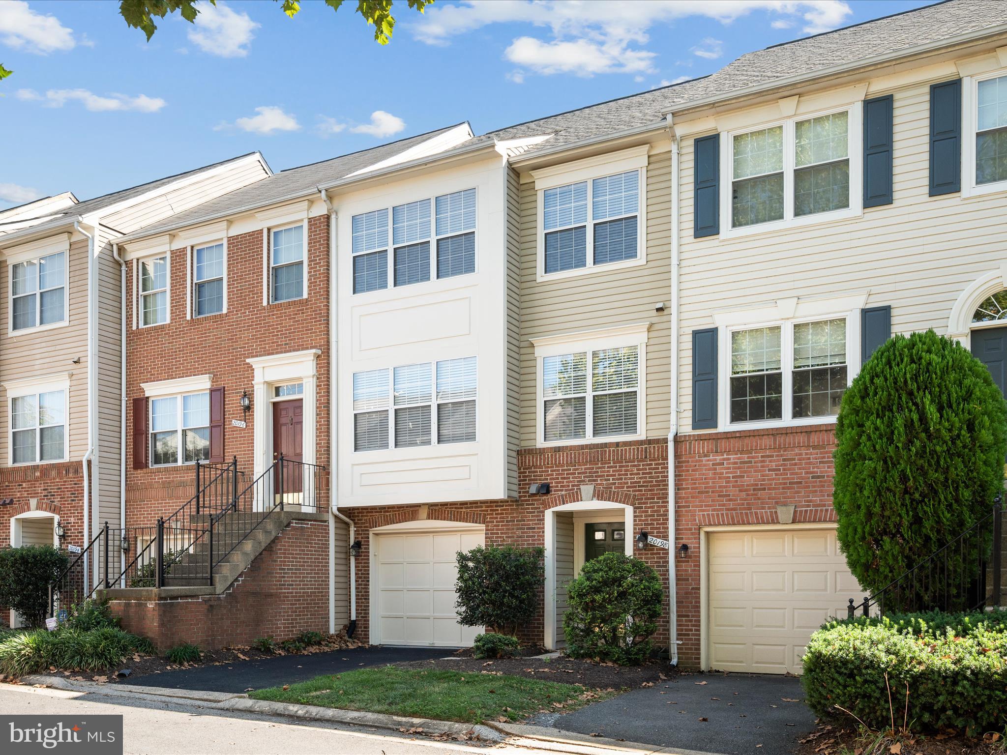 20198 Brookview Square Ashburn, VA 20147 - Photo 2 of 61 a front view of a house with a yard