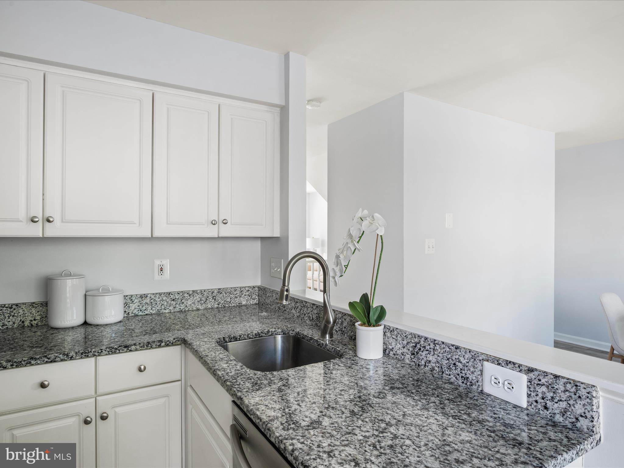 20198 Brookview Square Ashburn, VA 20147 - Photo 21 of 61 a kitchen with granite countertop a sink a stove and cabinets