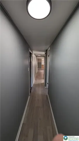 a view of hallway with wooden floor