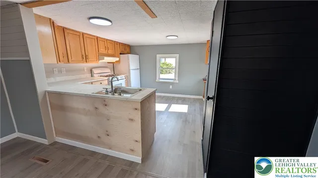 a bathroom with a sink a mirror and a shower