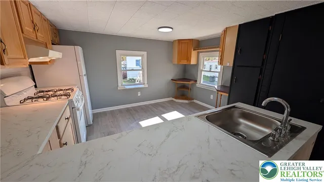 a kitchen with a sink and a stove top oven