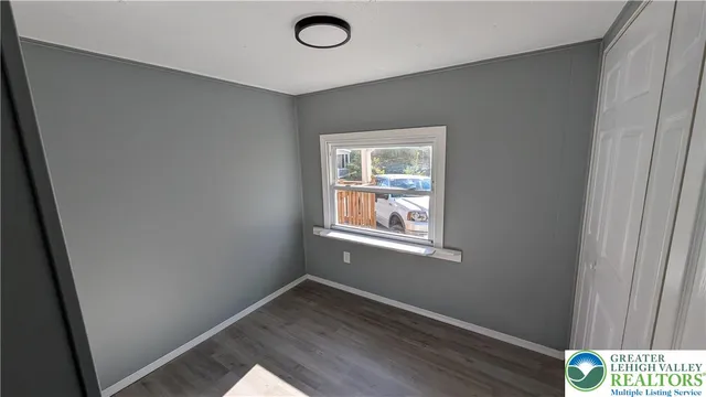 a view of an empty room and wooden floor
