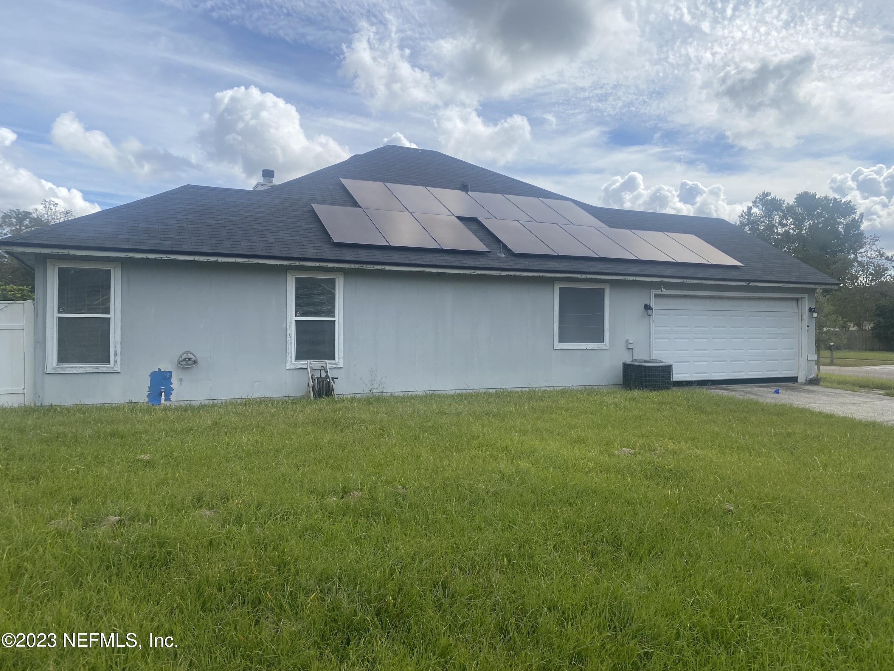 8359 Springtree Road Jacksonville, FL 32210 - Photo 2 of 3 a backyard of a house with lots of green space
