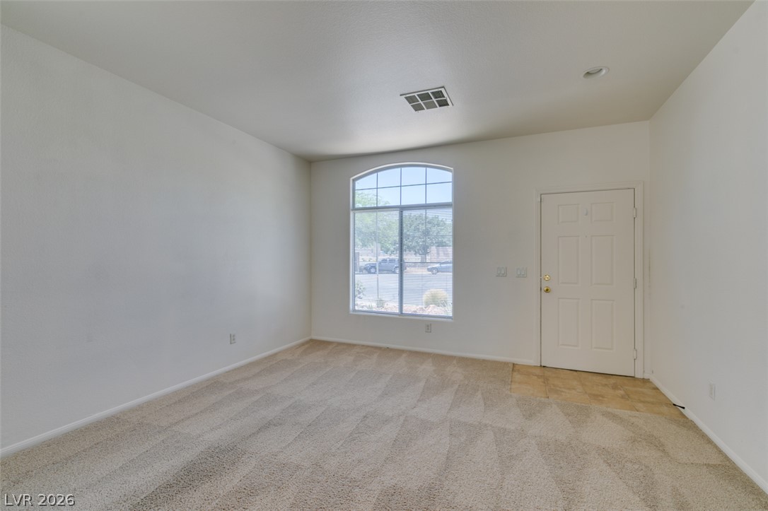 5150 Riverside Run Court North Las Vegas, NV 89081 - Photo 5 of 50 A gracefully arched window illuminates this comfortable living space, offering a pleasant neighborhood outlook.