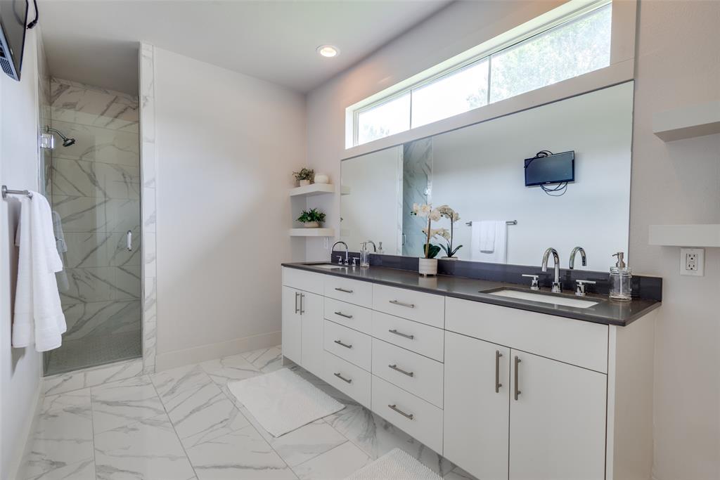 9803 Lakemont Drive Dallas, TX 75220 - Photo 10 of 13 a bathroom with a sink and a mirror