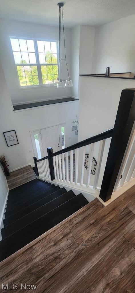 441 Rabbit Run Lane Wellington, OH 44090 - Photo 23 of 35 Stairway with wood-type flooring and a high ceiling