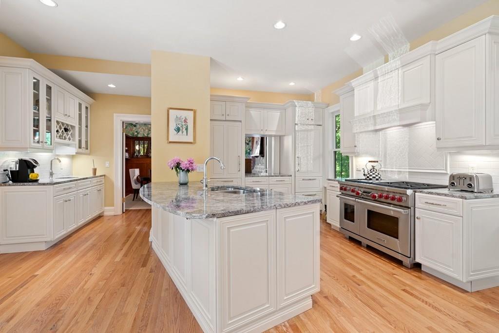 699 Boston Post Road Weston, MA 02493 - Photo 12 of 41 a large kitchen with stainless steel appliances granite countertop a lot of counter space and wooden floors
