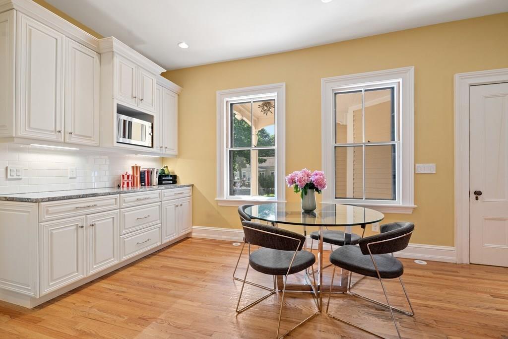699 Boston Post Road Weston, MA 02493 - Photo 13 of 41 a kitchen with granite countertop dining table chairs and granite counter tops