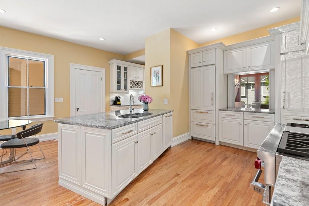 699 Boston Post Road Weston, MA 02493 - Photo 15 of 41 a kitchen with granite countertop a stove and white cabinets