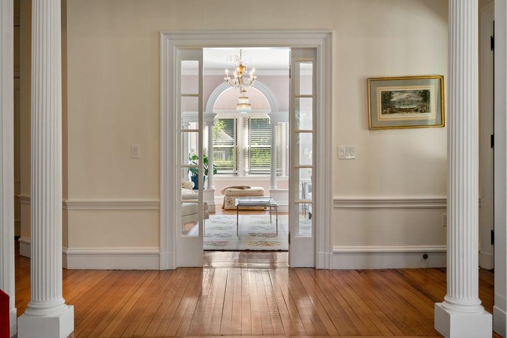 699 Boston Post Road Weston, MA 02493 - Photo 20 of 41 a view of a hallway with wooden floor and a living room