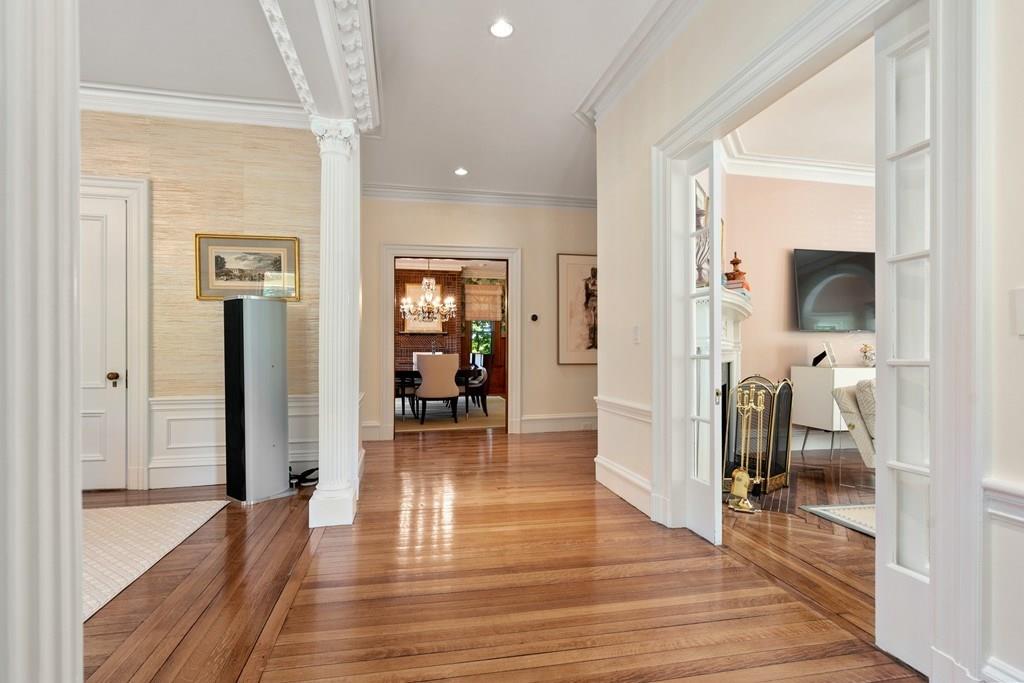 699 Boston Post Road Weston, MA 02493 - Photo 22 of 41 a view of a hallway with wooden floor and a living room
